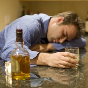 young man passed out from drinking alcohol