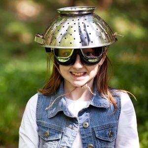 Young girl with a colander safety hat and goggles