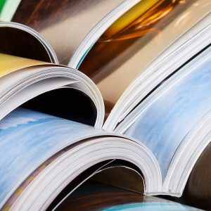 Close-up of stack of colorful magazines. Press news and magazines concept