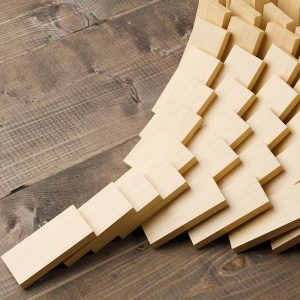 Wooden domino stones pyramid on wood floor falling over, chain reaction or multiplication effect concept, 3D illustration