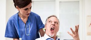 Patient on a wheelchair getting angry with nurse