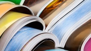 Close-up of stack of colorful magazines. Press news and magazines concept