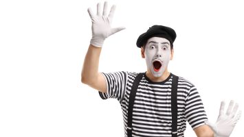 Mime holding his hands against an invisible wall isolated on white background