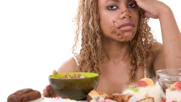 Pretty black woman looking very sick after having eating too much