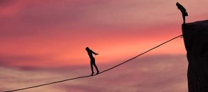 Silhouette of young businesswoman called on all her courage to walk on the rope at mountain. Business challenge concept
** Note: Visible grain at 100%, best at smaller sizes