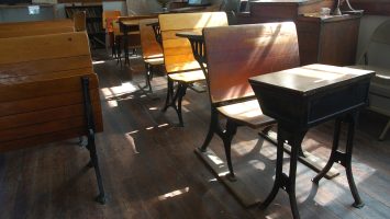 a recreation of a one-room school house using antiques in a museum.